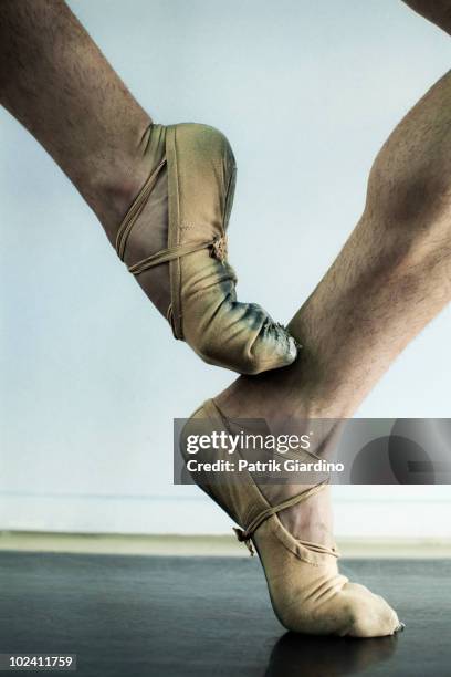 male ballet dancer balancing on toe. - male feet stock pictures, royalty-free photos & images