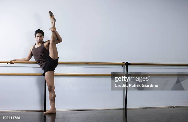 male ballet dancer stretching in dance studio - la art show stock pictures, royalty-free photos & images