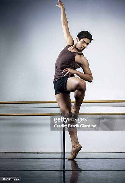 ballet dancer extending arm while dancing. - adult male vest exercise stock pictures, royalty-free photos & images