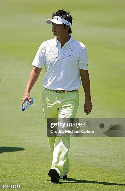 Ryuji Imada of Japan walks on the fairway during the second round of the Travelers Championship held at TPC River Highlands on June 25, 2010 in...