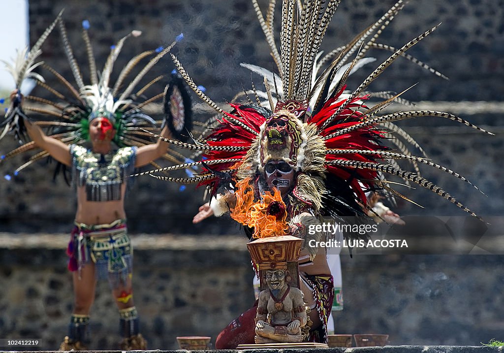 Aztec Ritual Impersonators An actor impersonating an Aztec priest lights the fire to be taken to ...
