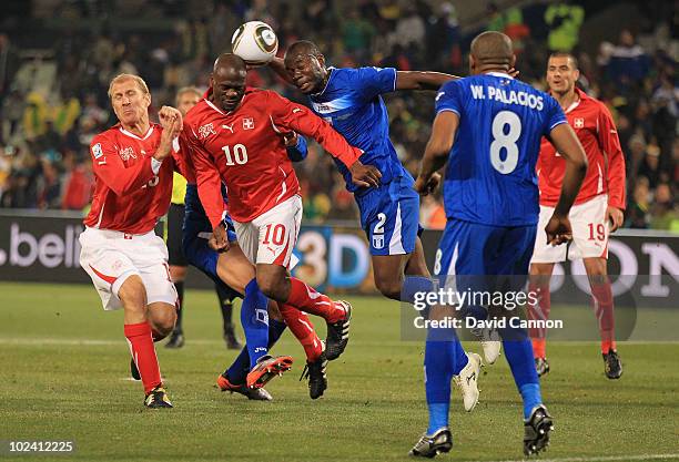 Blaise Nkufo of Switzerland and Osman Chavez of Honduras jump for the ball during the 2010 FIFA World Cup South Africa Group H match between...