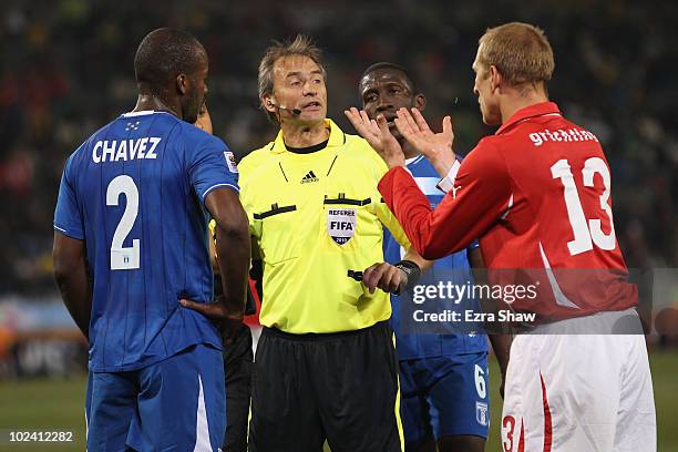 Stephane Grichting of Switzerland speaks to referee Hector Baldassi while Osman Chavez of Honduras looks on during the 2010 FIFA World Cup South...