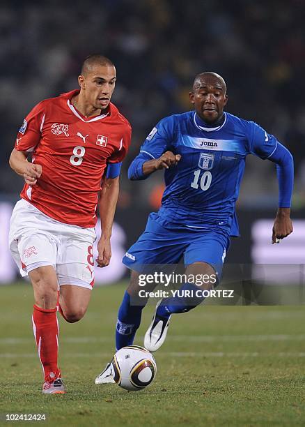 Switzerland's midfielder Goekhan Inler and Honduras' midfielder Jerry Palacios fight for the ball during the Group H first round 2010 World Cup...