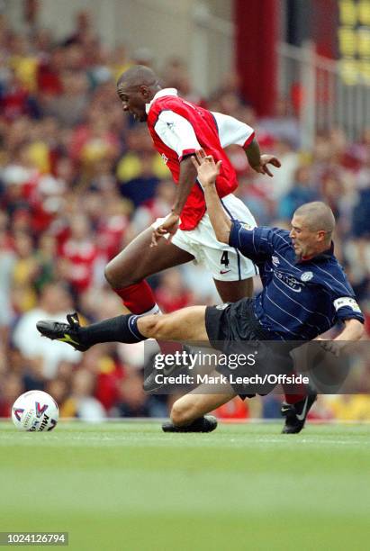 August 1999 - Premiership Football - Arsenal v Manchester United - Roy Keane of Manchester United stretches to tackle Patrick Vieira of Arsenal -