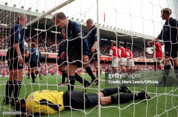 August 1999 - Premiership Football - Arsenal v Manchester United - Roy Keane and Phil Neville of Manchester United stand over injured goalkeeper...