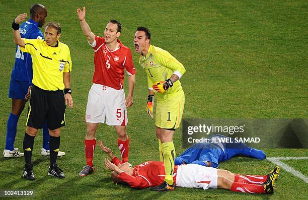 Switzerland's goalkeeper Diego Benaglio calls for medics as Switzerland's defender Stephane Grichting lies on the pitch next to Honduras' midfielder...