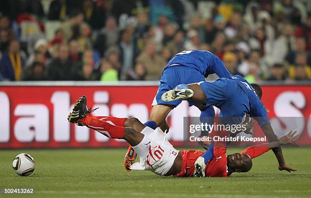 Blaise Nkufo of Switzerland is tackled by Victor Bernardez and Osman Chavez of Honduras during the 2010 FIFA World Cup South Africa Group H match...