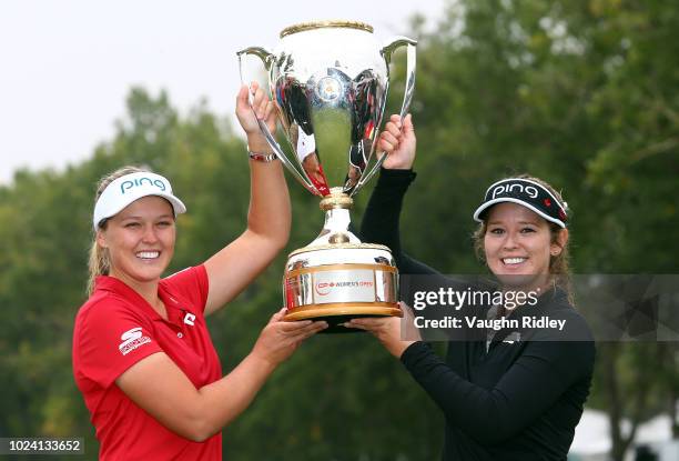 Brooke Henderson of Canada with the champions trophy and her sister & caddie, Brittany, following the final round of the CP Womens Open at the...