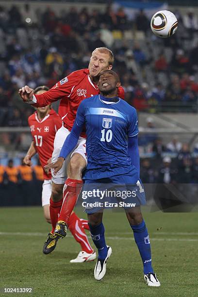 Jerry Palacios of Honduras collides with Stephane Grichting of Switzerland as they jump for the ball during the 2010 FIFA World Cup South Africa...