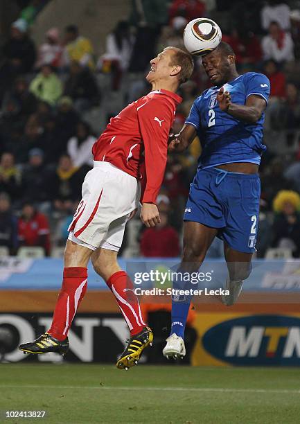 Stephane Grichting of Switzerland and Osman Chavez of Honduras jump for the ball during the 2010 FIFA World Cup South Africa Group H match between...