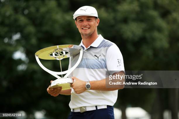 Bryson DeChambeau of the United States celebrates with the winner's trophy after the final round of The Northern Trust on August 26, 2018 at the...