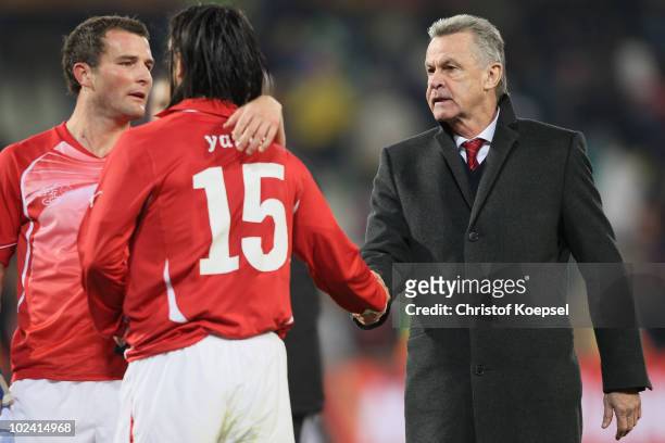Ottmar Hitzfeld head coach of Switzerland consoles dejected Hakan Yakin of Switzerland after a goalless draw and elimination from the tournament...