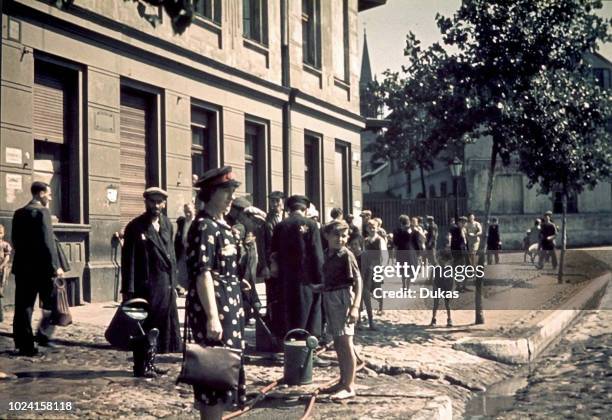 Ghetto Lodz, Litzmannstadt, A doctor near a water tap in a ghetto street, Poland 1942, World War II.