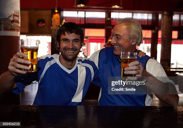 father and son smiling in bar - parallel bars stock-fotos und bilder