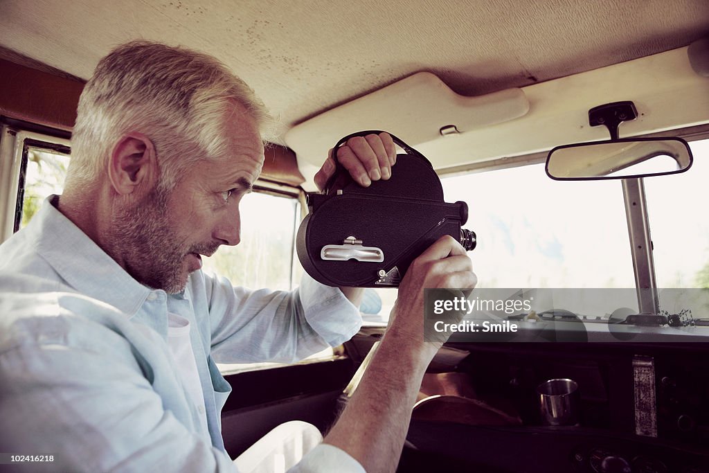 Man filming through off road vehicle's window