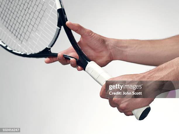 hands holding a tennis racket - tennis racket imagens e fotografias de stock
