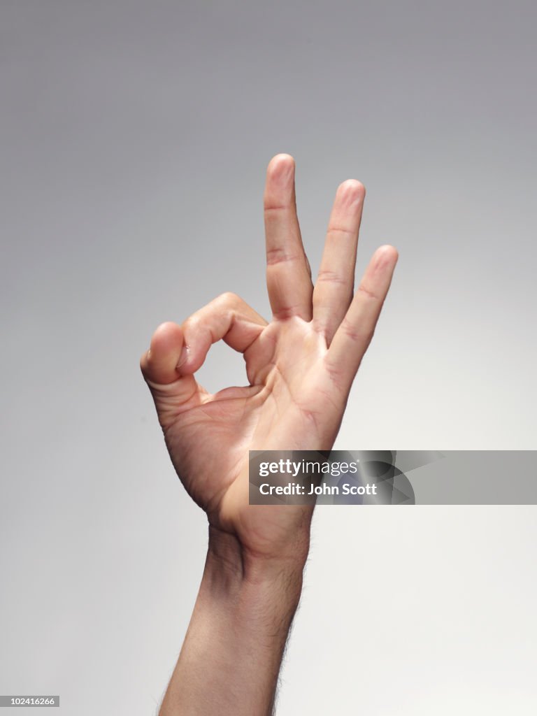 Hand making an ok sign