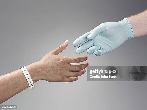 patient and doctor shaking hands - surgical glove stock pictures, royalty-free photos & images