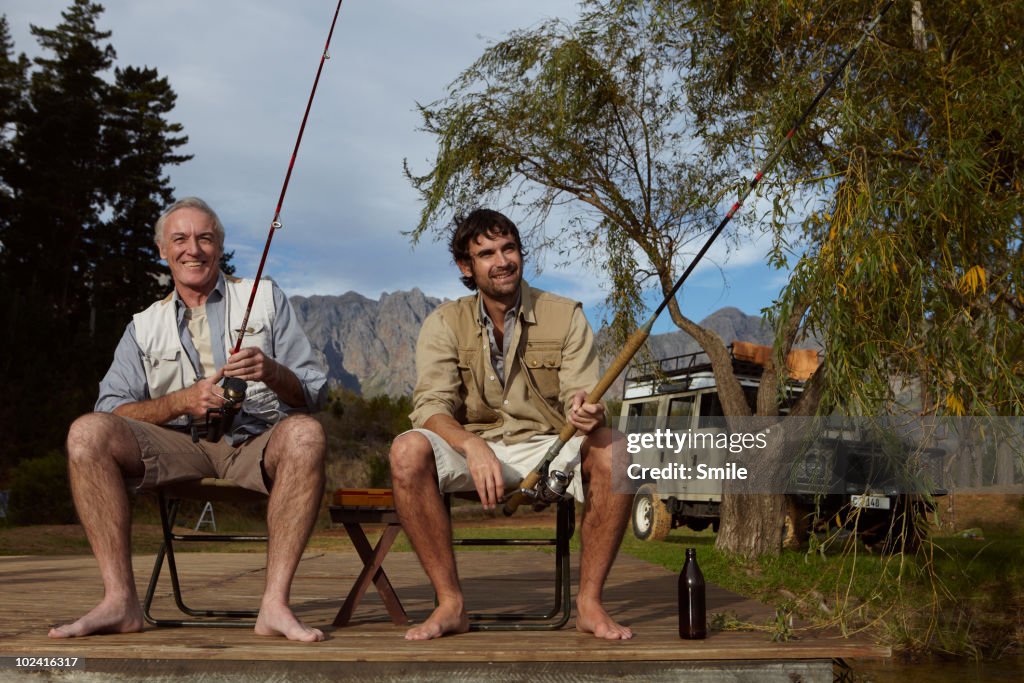 Father and son fishing on jetty