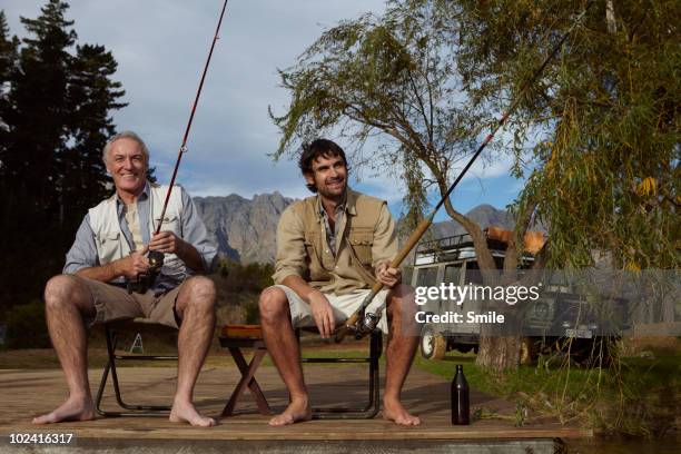 father and son fishing on jetty - man fishing stock pictures, royalty-free photos & images