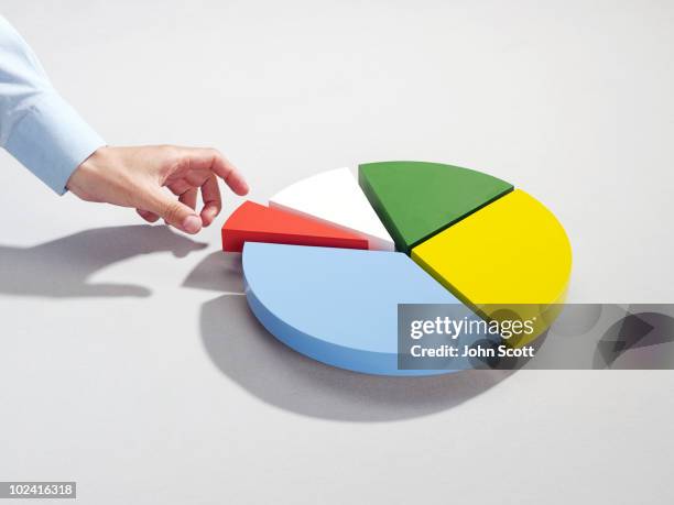 man reaching for segment of pie chart - circle graph stock pictures, royalty-free photos & images