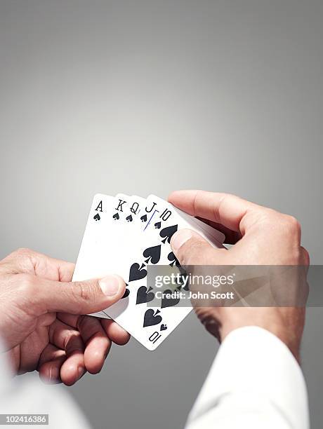 hands holding playing cards - hand of cards stock-fotos und bilder