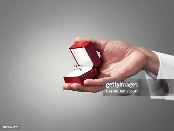 man holding engagement ring, close-up of hand - caixa de joias imagens e fotografias de stock