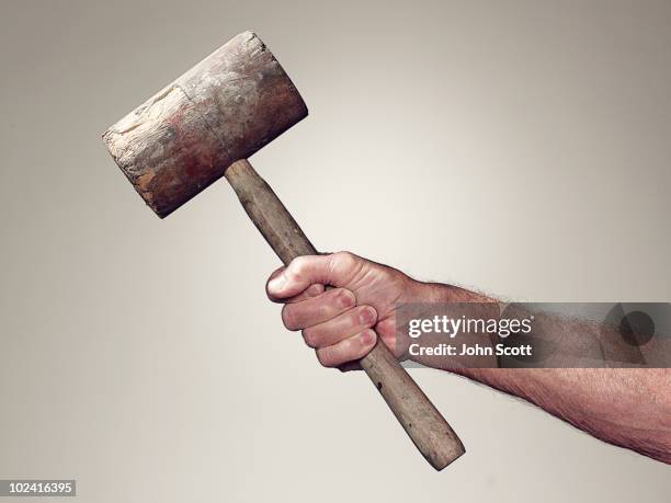 hand holding wooden mallet - hamer stockfoto's en -beelden