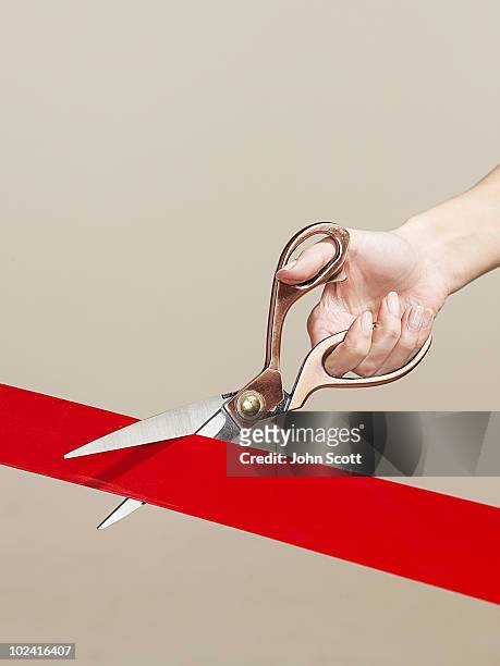 woman using scissors to cut opening ribbon - inaugurazione foto e immagini stock