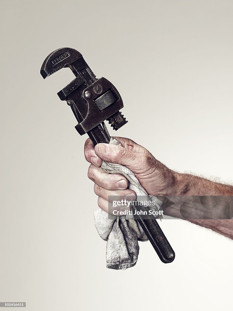 Hand holding spanner/wrench