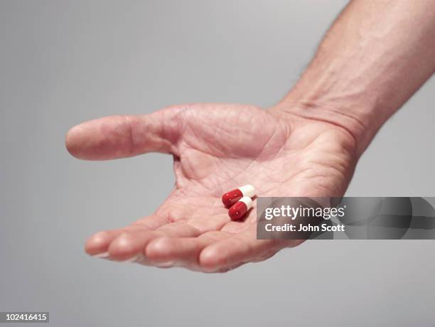 Pill Hand Hand Holding Pill Photos and Premium High Res Pictures - Getty Images