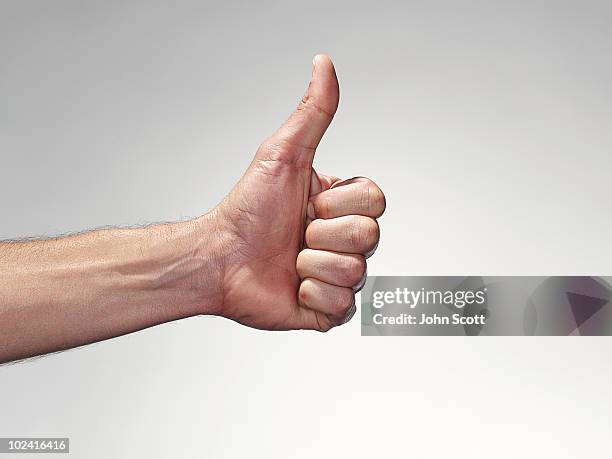 hand giving the thumbs up - john good stock pictures, royalty-free photos & images