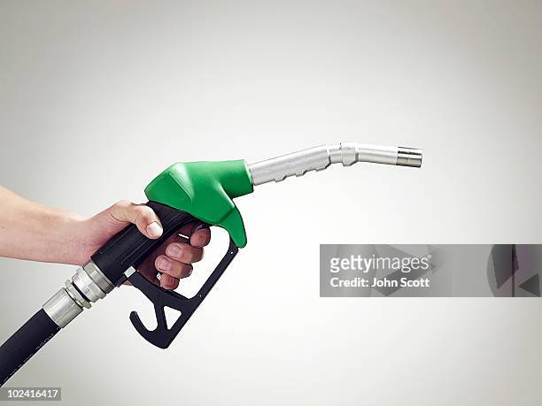 man holding a petrol pump, close-up of hand - combustível fóssil - fotografias e filmes do acervo