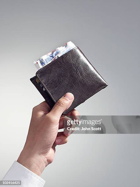 man holding wallet, close-up of hand - wallet stockfoto's en -beelden