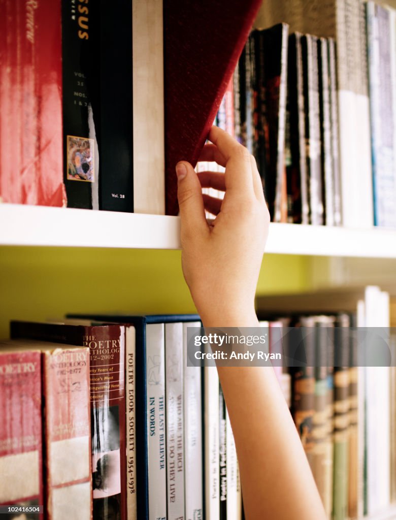 Library Hand Examples Girls Hand Choosing Book From Library Shelf Photo - Getty Images