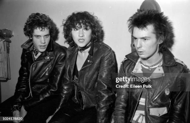 View of, from left, Rick Static, Michele Robison, and British musician Sid Vicious as they sit backstage at the Palladium, New York, New York,...