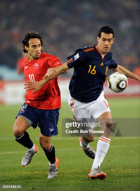 Sergio Busquets of Spain shields the ball from Jorge Valdivia of Chile during the 2010 FIFA World Cup South Africa Group H match between Chile and...