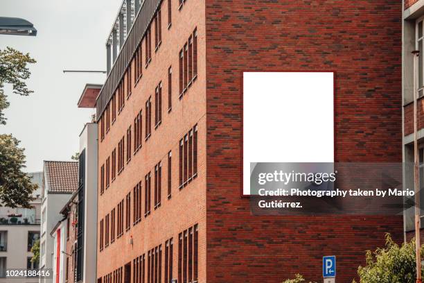 blank billboard on building facade - building billboard stock pictures, royalty-free photos & images