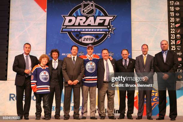 Taylor Hall, drafted overall by the Edmonton Oilers, poses with team personnel during the 2010 NHL Entry Draft at Staples Center on June 25, 2010 in...