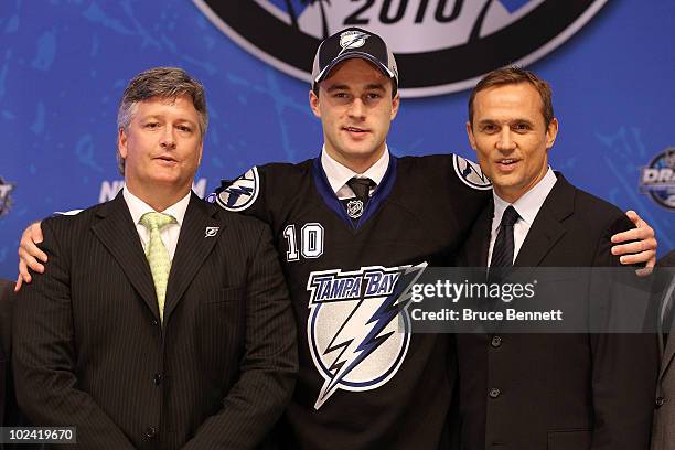 Brett Connolly, drafted sixth overall by the Tampa Bay Lightning, poses on stage with team personnel during the 2010 NHL Entry Draft at Staples...