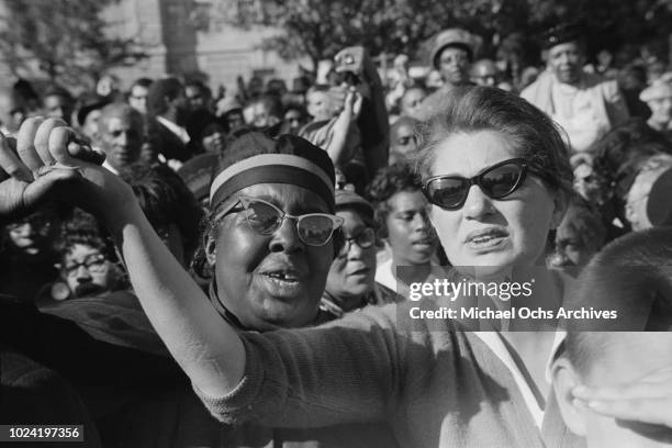 Women holding hands at a civil rights demonstration in Washington, DC, in the aftermath of the 16th Street Baptist Church bombing in Birmingham,...