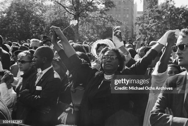 People holding hands at a civil rights demonstration in Washington, DC, in the aftermath of the 16th Street Baptist Church bombing in Birmingham,...