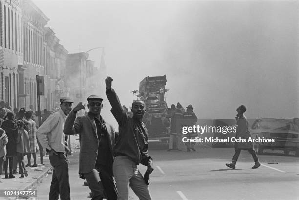 Firefighters tackle a burning building during a period of rioting in Baltimore, Maryland, following the assassination of civil rights activist Martin...