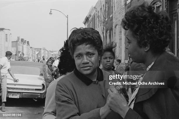 Women comforting each other during a period of rioting in Baltimore, Maryland, following the assassination of civil rights activist Martin Luther...