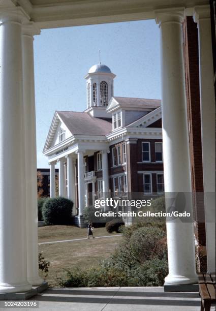 View through pillars of a colonnade towards building at Asbury University, a Christian liberal arts university in Wilmore, Kentucky, 1955.