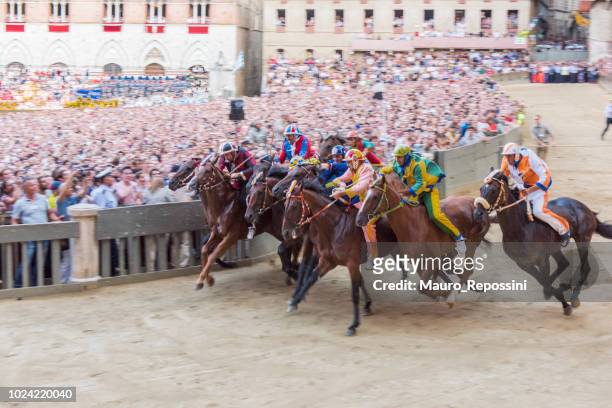 start of the race the "palio di siena" at the piazza di campo at siena city, italy. - palio di siena stock pictures, royalty-free photos & images