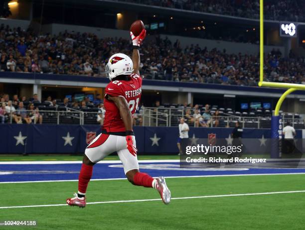 Patrick Peterson of the Arizona Cardinals carries the ball to the end zone for a touchdown after an interception in the first quarter of a preseason...