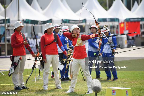 The Chinese team of Hui Cao, Yuejun Zhai and Xinyan Zhang prepare during Recurve Women's Team Archery Final Rounds on day nine of the Asian Games on...