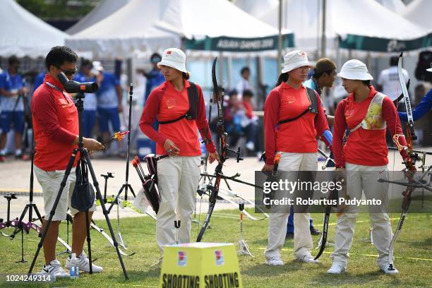 The Chinese team of Hui Cao, Yuejun Zhai and Xinyan Zhang prepare during Recurve Women's Team Archery Final Rounds on day nine of the Asian Games on...